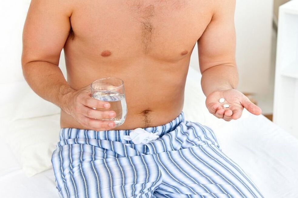 un homme prend des pilules contre la prostatite